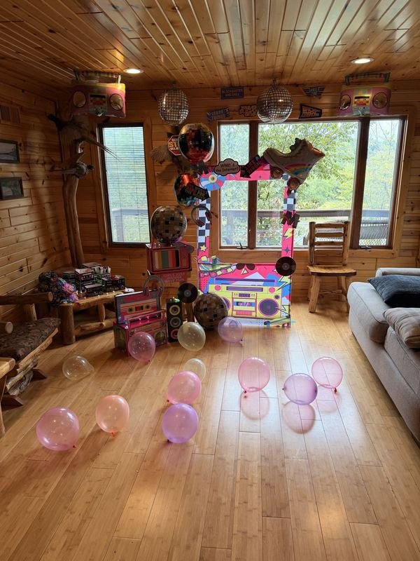 Retro themed party setup with pink bubble balloons
