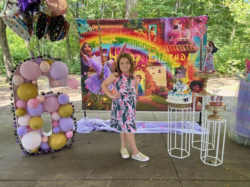 Outdoor rainbow backdrop with a balloon-filled number six