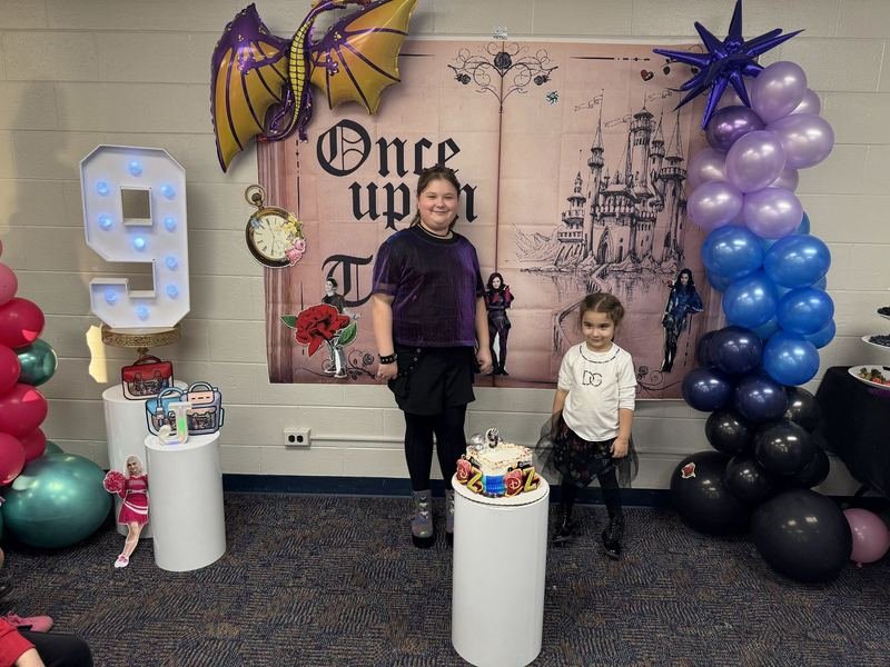 Storybook castle backdrop with purple, blue and black balloon column