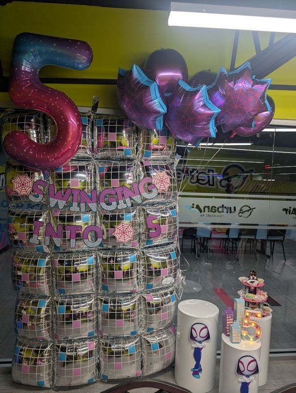 Disco-ball balloon wall with a giant number five